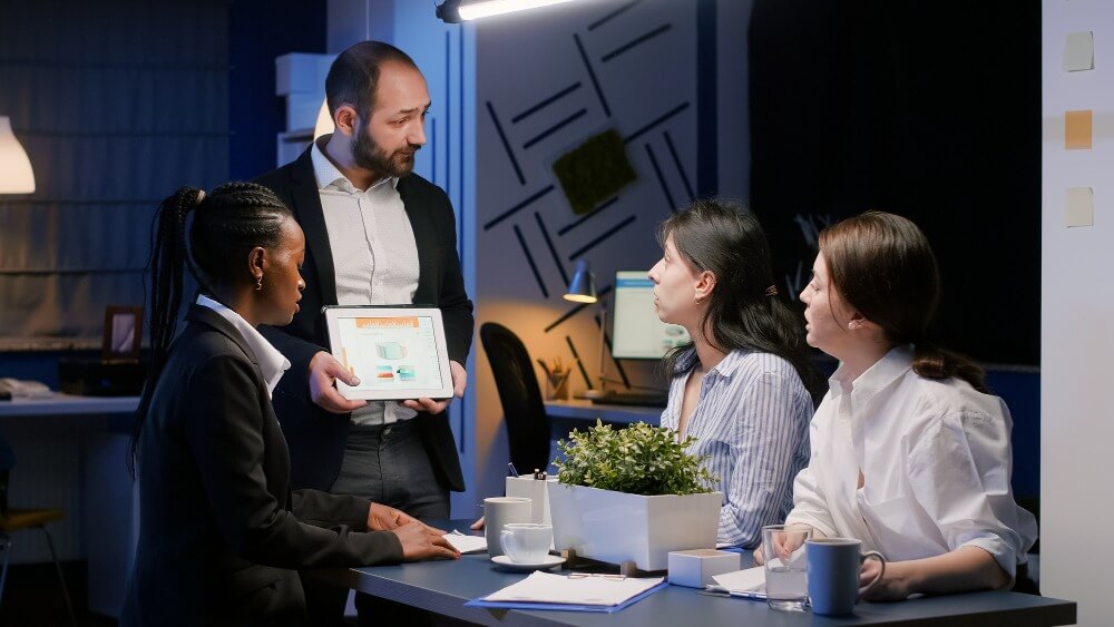 Manager showing employees how a Customer community platform will help their brand grow their customer community